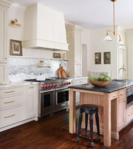 Created by Karr Bick - Photo by Lisa Mitch Door Style/Colors: Olympia Door Style perimeter in Painted Maple Match to Farrow & Ball “Old White”, Island is Select Alder Cognac