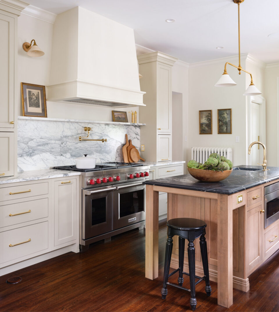 Created by Karr Bick - Photo by Lisa Mitch Door Style/Colors: Olympia Door Style perimeter in Painted Maple Match to Farrow & Ball “Old White”, Island is Select Alder Cognac